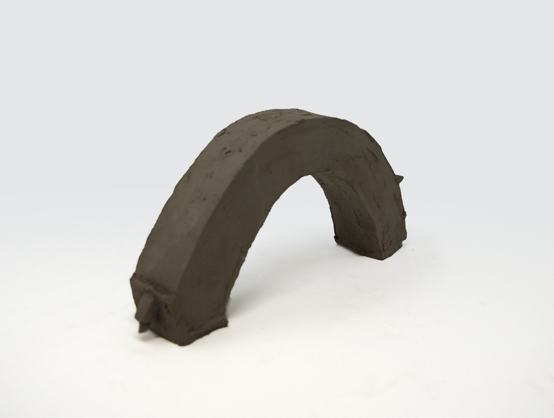 A pitched-roof house model curved into an arch for Alternative Histories.