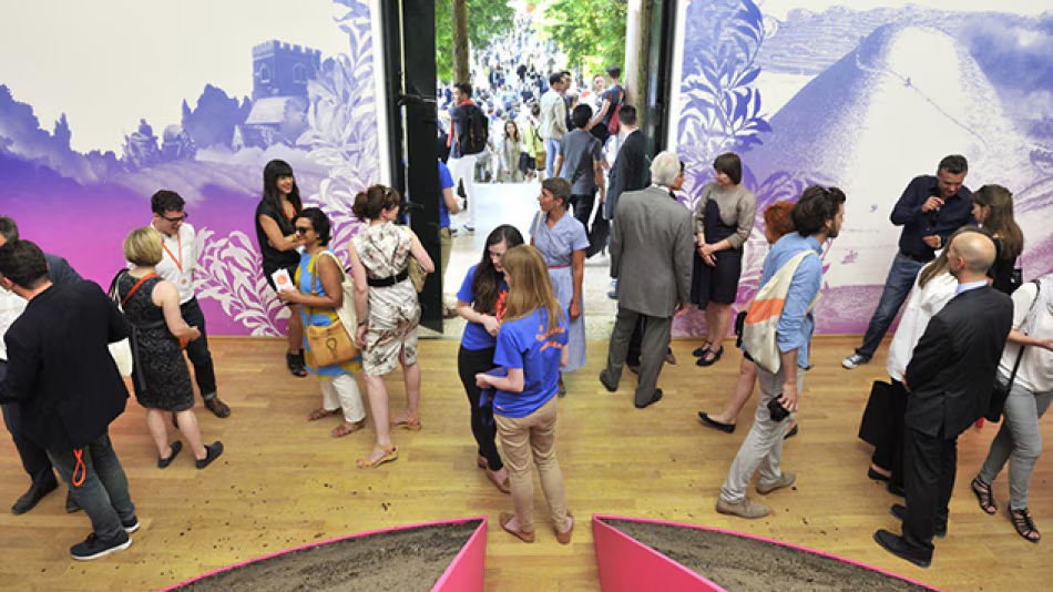 Visitors enter the central gallery beneath a panoramic image of British culture.