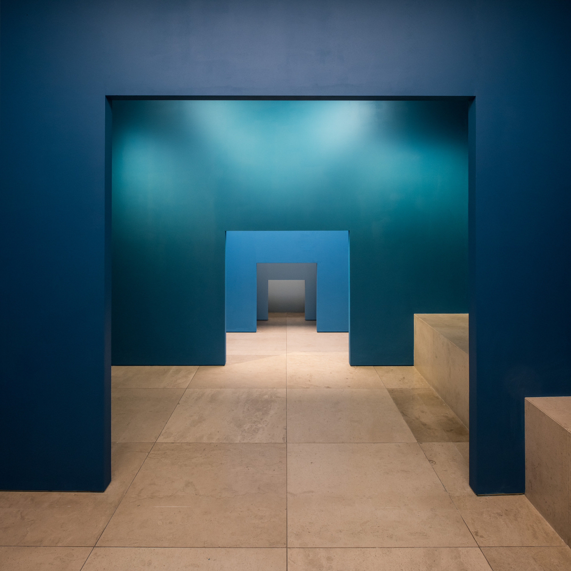 Disappear Here: A sequence of blue doorways seen along a single axis