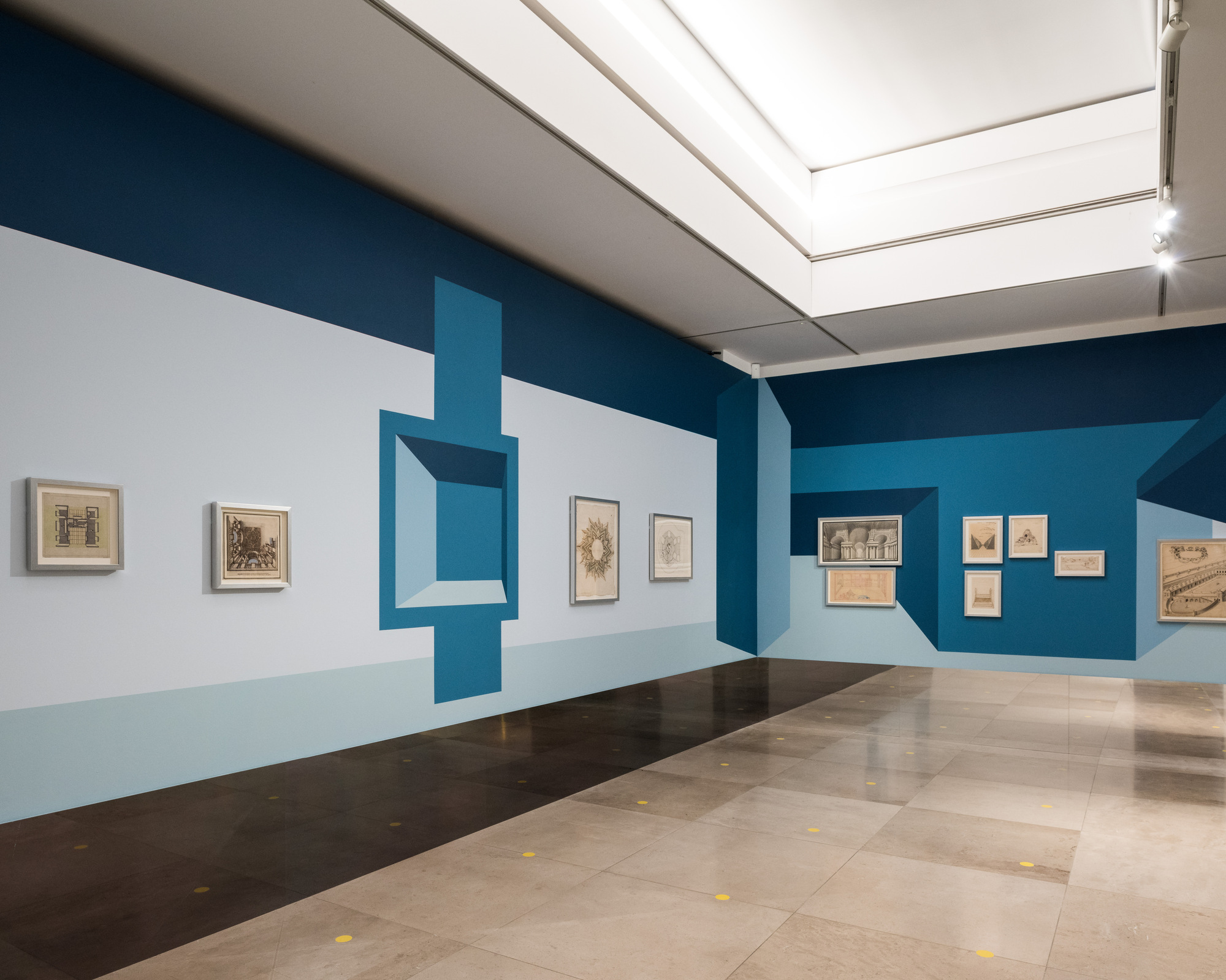 Disappear Here: Wide view of two adjoining walls painted in shades of blue