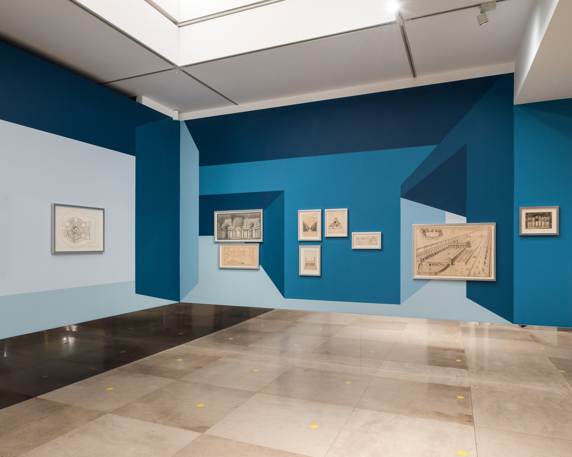 Disappear Here: Perspective painting and framed drawings continuing across a gallery corner