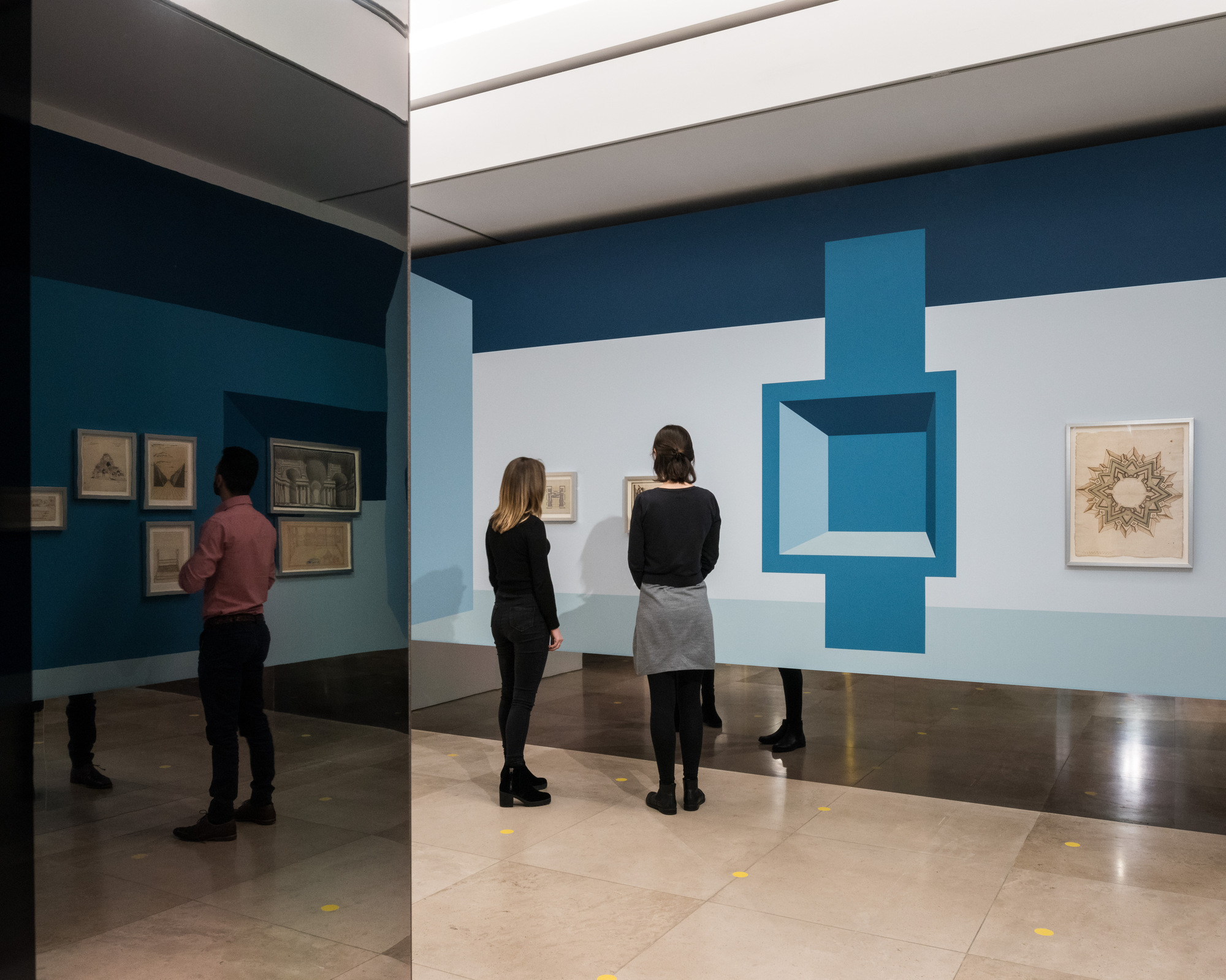 Disappear Here: Visitors and gallery drawings reflected in a mirrored column