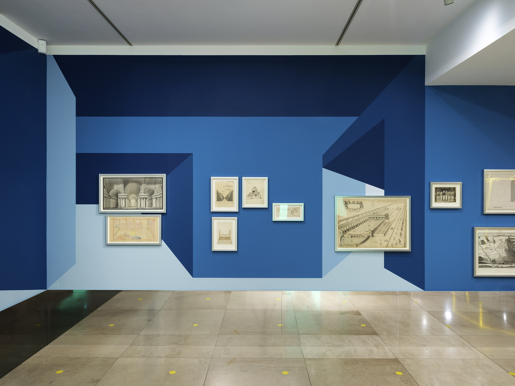 Disappear Here: A group of historic architectural drawings against the blue wall painting