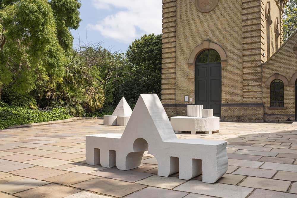 Close view of the white sculptural furniture outside the gallery