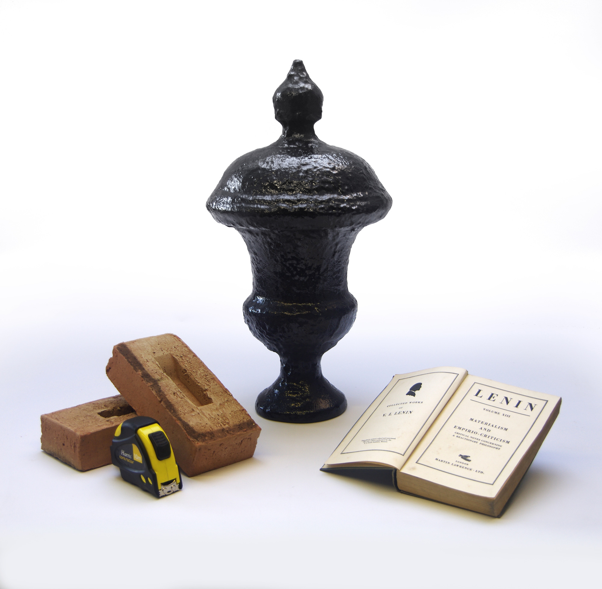 Lenin’s Urn alongside bricks, a tape measure and an open volume of Lenin