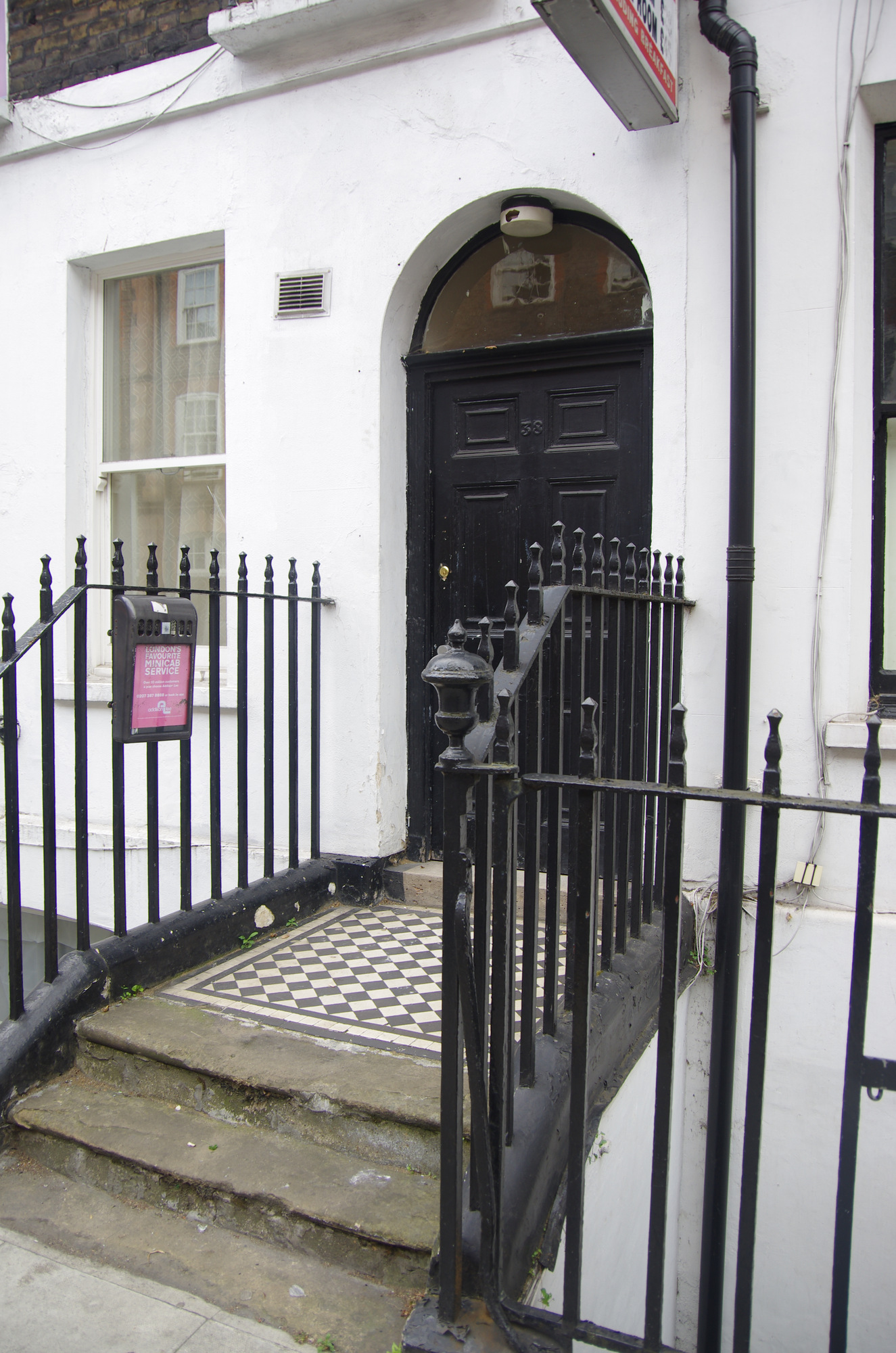 The railing finial outside a doorway at number 36