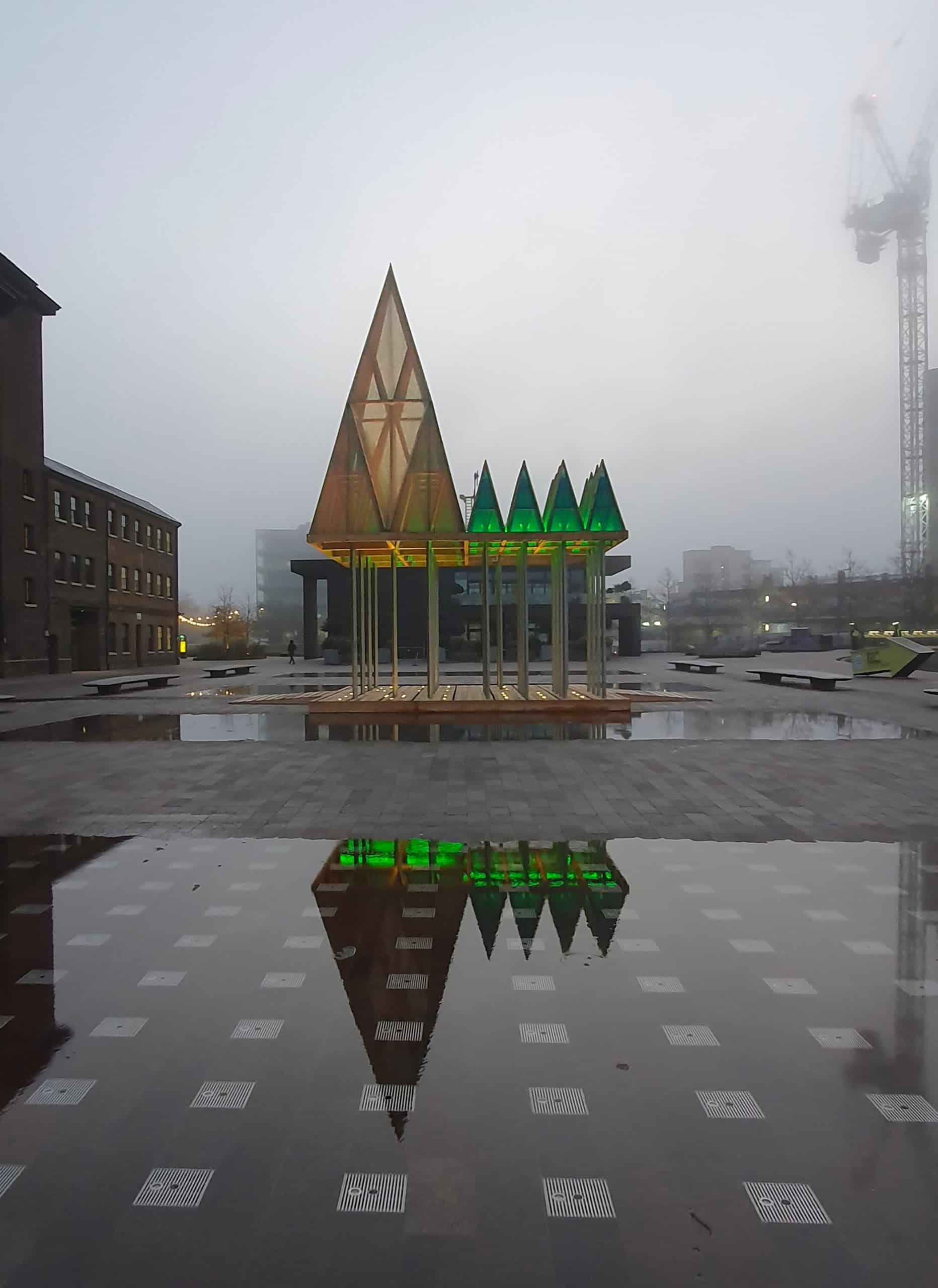 The Electric Nemeton reflected in rainwater in Granary Square