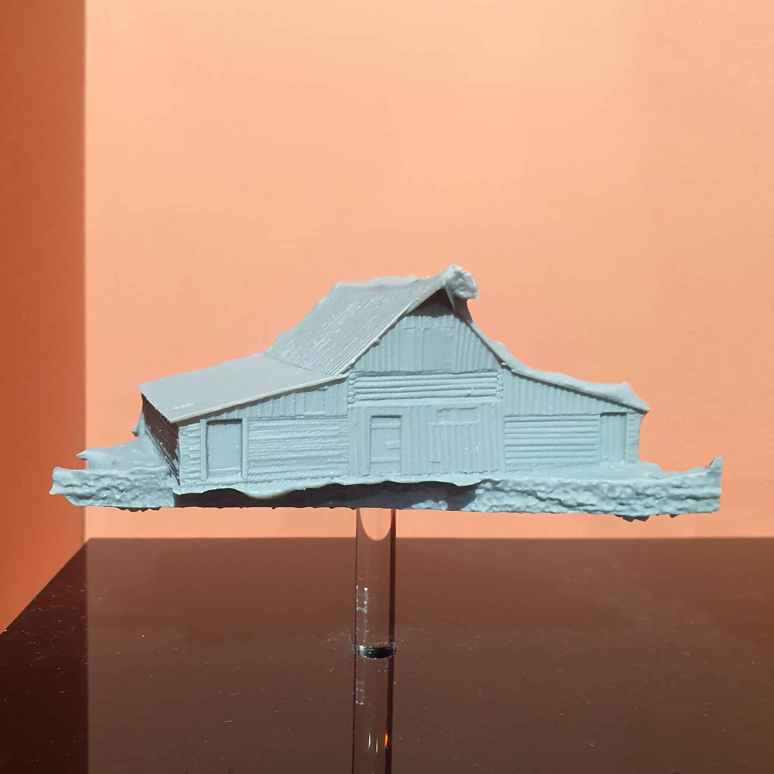 Side view of a pale-blue 3D-printed barn